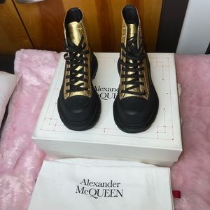 Alexander McQueen black and gold ankle boots.